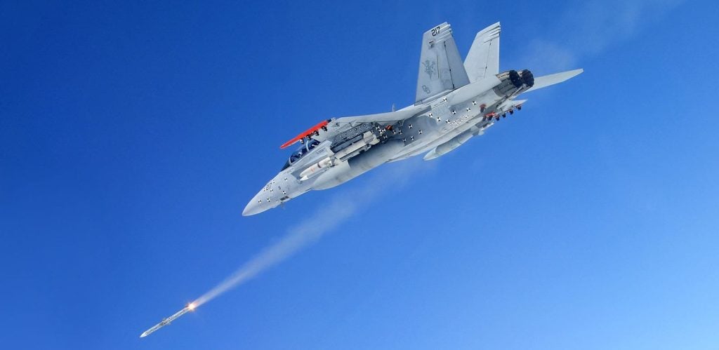 An F-18 fighter launches an AIM-120 AMRAAM missile